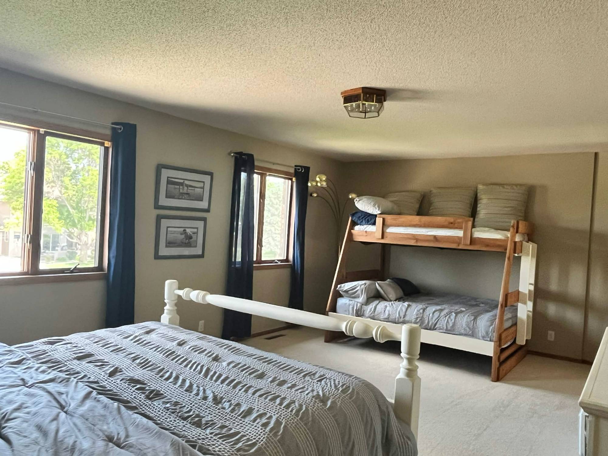 Bedroom with queen bed and wooden bunk
