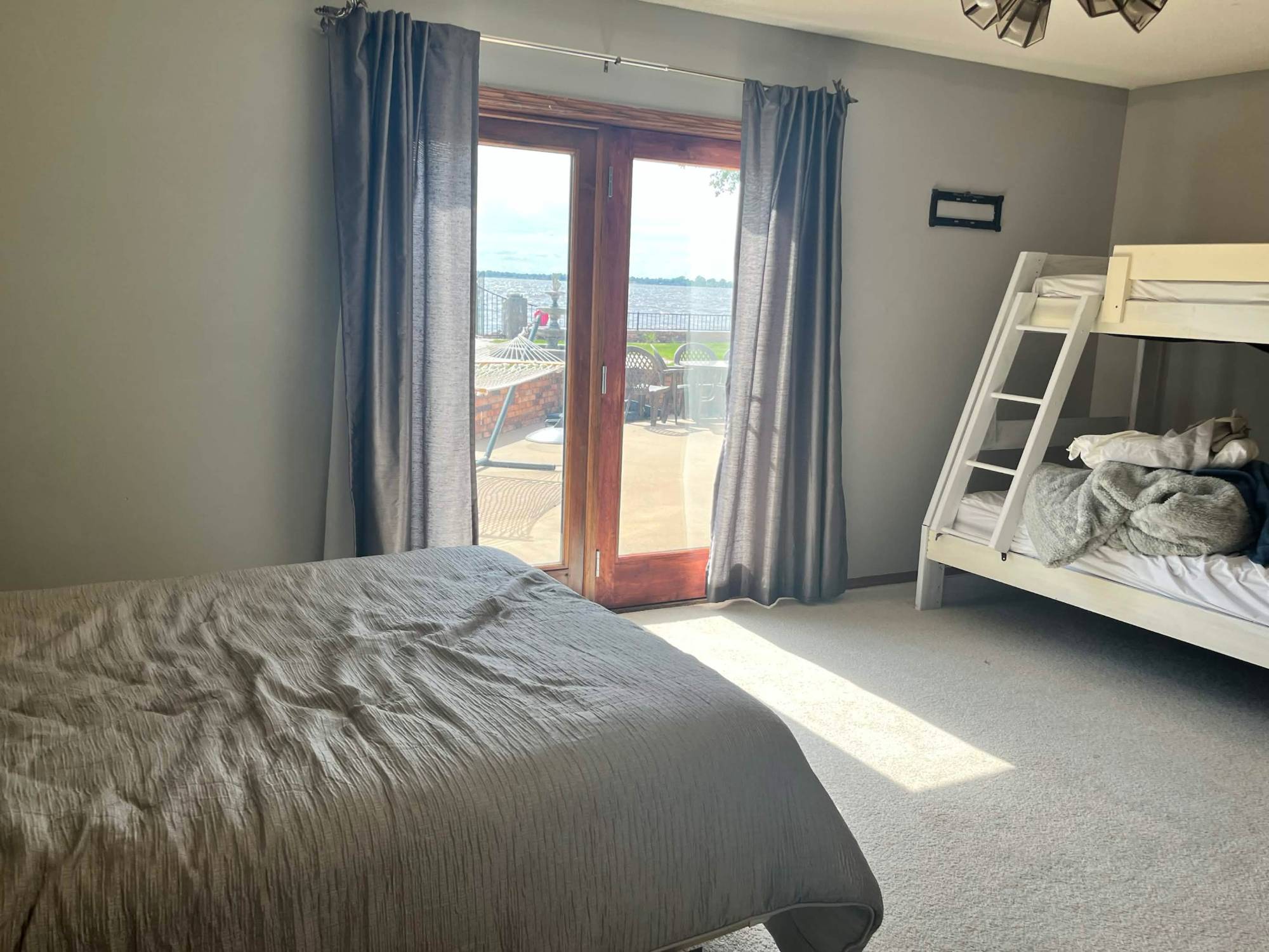 Bedroom with bunk bed and doors to the lakeside patio