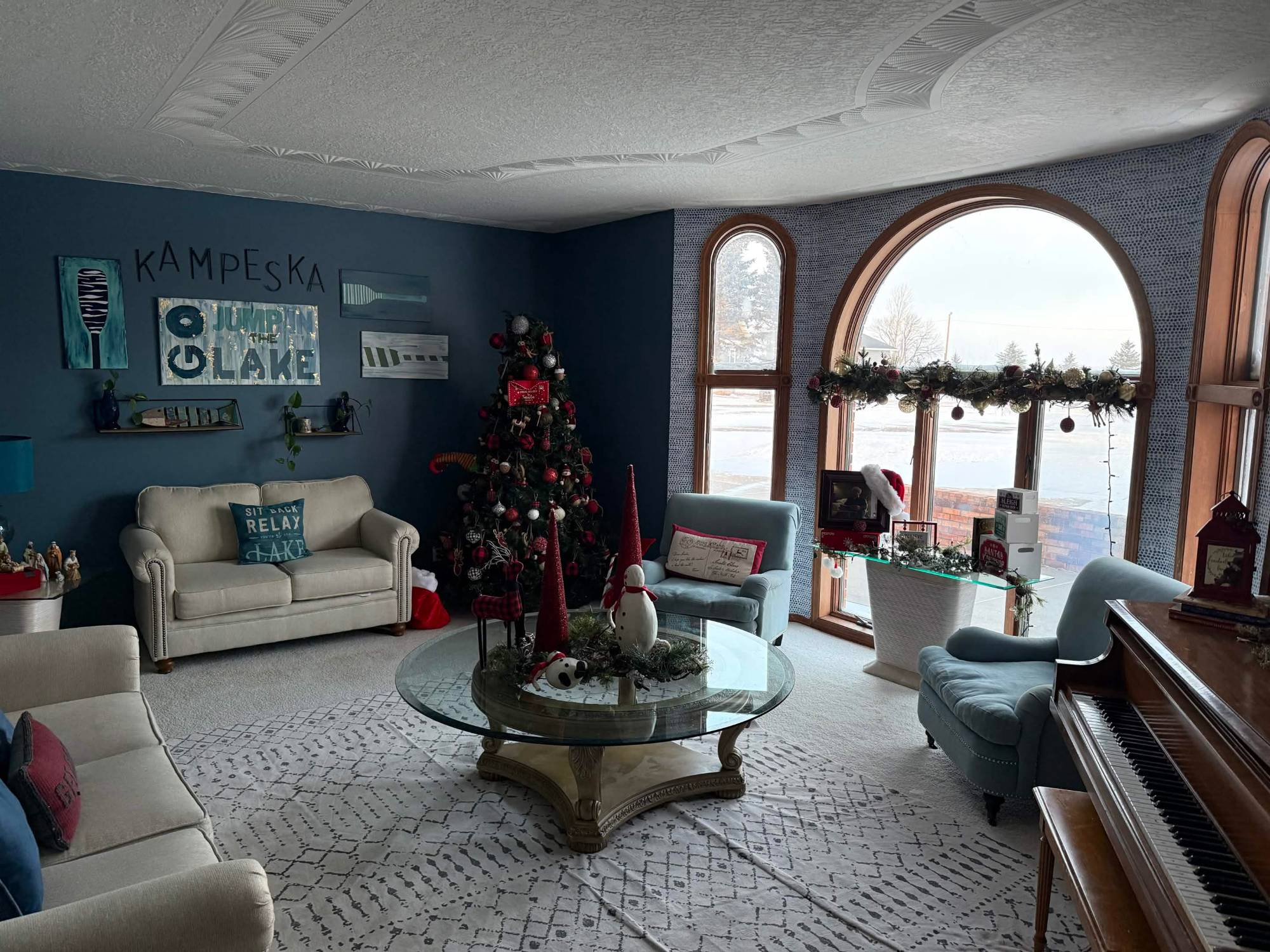 Front living room with blue walls, piano and arched windows